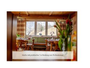a dining room with tables and chairs and a window at Ferienhaus Alpenblick, ganzes Ferienhaus, 5 Zi, 4 Bäder, gratis Parkplatz, Sonnenterrasse in Heiligenblut