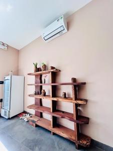 a room with wooden shelves next to a refrigerator at HOA GIO Boutique stay in Hue