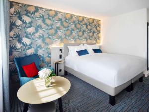 a hotel room with a bed and a table at Grand Hotel Bregenz - MGallery Collection in Bregenz