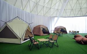a group of tents and chairs and tables in a room at Glamz at Genting in Genting Highlands