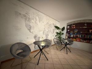 a room with three chairs and a table and a map at Agritur Girasole in Arco