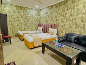 a living room with a couch and a table at Hotel Diamond View in Greater Noida