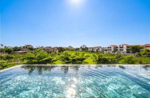 a swimming pool in the middle of a resort at Hoi An Chic - Green Retreat in Hoi An