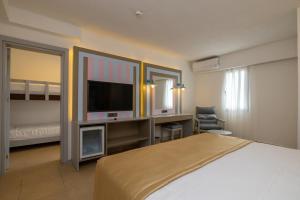 a bedroom with a bed and a flat screen tv at SOLANA By YELKEN in Turgutreis +19 photos