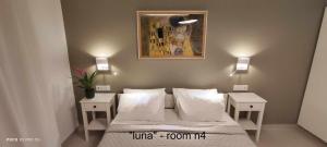a bedroom with a bed with two nightstands and a painting at Papadioti Apartments in Pefki +87 photos