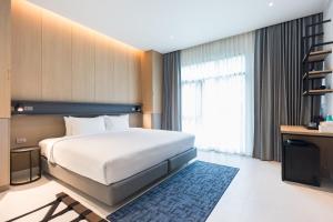 a hotel room with a bed and a television at Maraleina Sports Resort in Nathon Bay