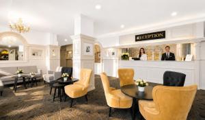 a salon with chairs and tables and a reception desk at Hotel Uno Prague in Prague