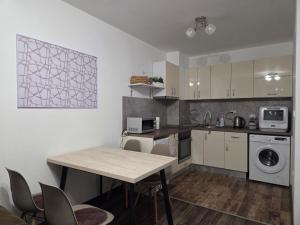 a kitchen with a table and chairs in a room at Azaria in Hisarya