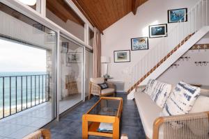 a living room with a view of the ocean at La Proue , duplex face mer in Arzon