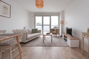 a living room with a couch and a tv at La belle étoile - 4 pers - balcon in Vannes