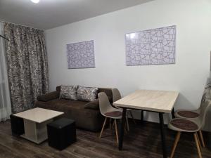 a living room with a couch and a table at Azaria in Hisarya