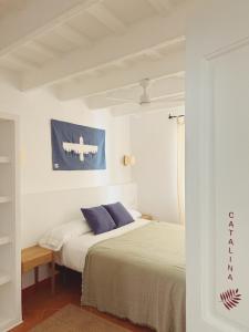 a bedroom with a bed and an airplane painting on the wall at Hotel Casa Fiets in Alaior +26 photos