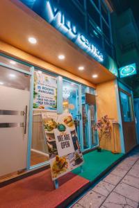 a sign in the window of a pizza shop at Vilu Central in Hulhumale