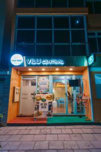 a building with a sign on the front of a restaurant at Vilu Central in Hulhumale