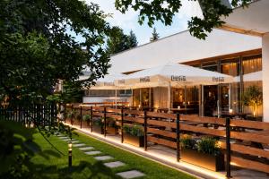 a restaurant with tables and umbrellas in front of a building at Hotel Uno Prague in Prague +16 photos