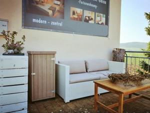 a living room with a couch and a coffee table at Stadtapartement Geisa in Geisa +1 photo