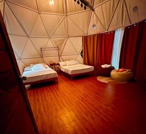 a room with two beds in a tent at CAELO | Peaceful Mountain View Rive in Pililla