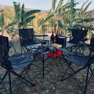 a table and chairs with food on top of it at CAELO | Peaceful Mountain View Rive in Pililla