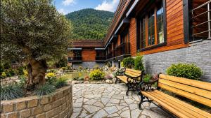 a couple of benches sitting outside of a building at Sezgin Hotel in Uzungöl