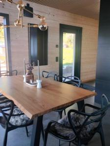 a large wooden table with chairs in a room at Villa Vaalanto in Pomarkku +15 photos