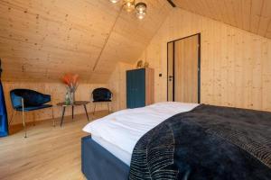 a bedroom with a bed and a table and chairs at Comfortable holiday home, pool, sauna, jacuzzi in Kopań +40 photos