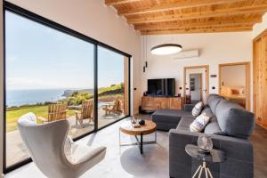a living room with a view of the ocean at Casa Al Mare in Canto da Areia