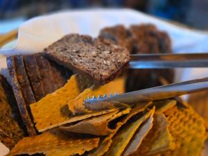 a person holding a plate of food with a knife at B&B Bokkeleane in Kolderwolde