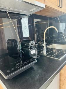 a kitchen counter with a stove and a sink at Faidrahouse in Alyki +69 photos