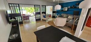 a living room with a couch and a table at Charming house in Mauritius in Bain Boeuf