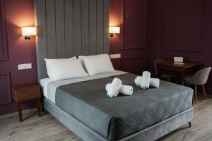 a bedroom with a bed with two pillows on it at Archontiko Kiverniti in Pano Lefkara +54 photos