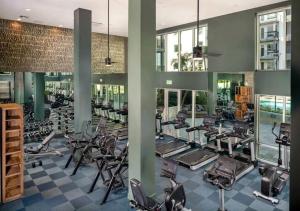 a gym with a lot of treadmills and ellipticals at Artistic Getaway 10 Min to Disneyland With Pool&GYM in Tustin