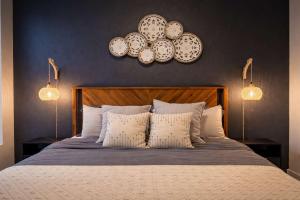 a bedroom with a bed with two plates on the wall at Artistic Getaway 10 Min to Disneyland With Pool&GYM in Tustin +64 photos