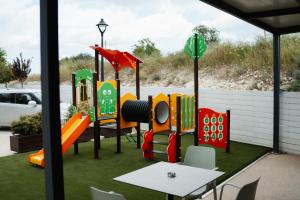 a play yard with a playground with a table at Archontiko Kiverniti in Pano Lefkara