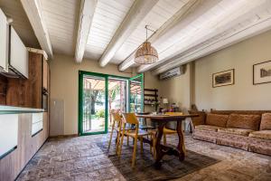 a living room with a table and chairs and a couch at All'ombra della quercia in Fano
