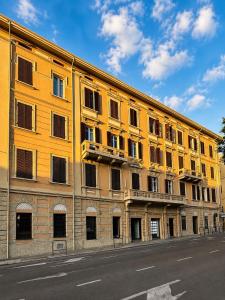 a large yellow building on the side of a street at Palazzo Pilo in Sassari