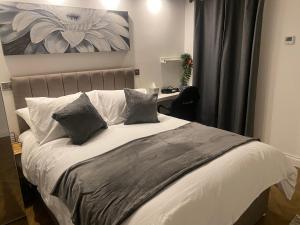 a bedroom with a large bed with two pillows at Holiday home with 3 double bedrooms all En-suite in Craven Arms