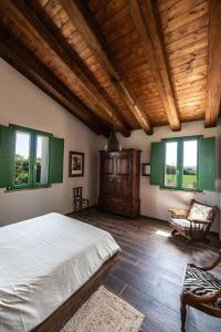 a bedroom with a bed and a wooden ceiling at All'ombra della quercia in Fano +22 photos