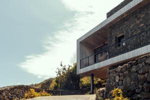 a house on the side of a mountain at Casa da Faia in São Roque do Pico