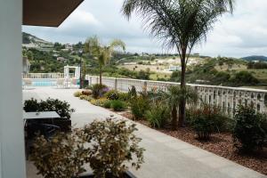 a patio with a white fence and a garden at Archontiko Kiverniti in Pano Lefkara