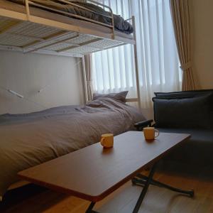 a bedroom with a bed and two cups on a table at Hotel Route35 Shiomi in Sasebo