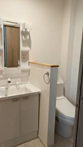 a white bathroom with a toilet and a sink at Hotel Route35 Shiomi in Sasebo +8 photos