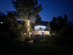 a house with lights on it at night at Countryside forest village in Udhampur