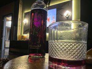 a bottle of wine and a glass on a table at Countryside forest village in Udhampur