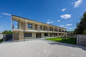 an exterior view of a building with a large driveway at DANUBike in Dobrohošť