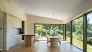 a kitchen and dining room with a table and chairs at Chalet DU MERLE - CHAMP DU FEU - NEUF 5 ETOILES in Belmont