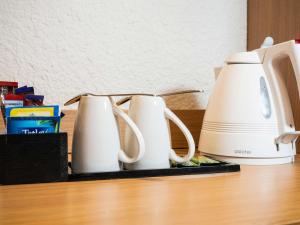 a row of white appliances sitting on a table at Novotel Southampton in Southampton