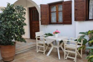 a table and chairs on a patio with a plant at Villa Fantasia in Skiathos