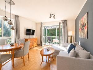 a living room with a couch and a table at Tivoli Apartments in Bad Reichenhall