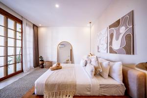 a bedroom with a large bed and a large window at Villa Ume Seseh in Munggu +36 photos