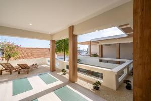an indoor pool with a view of a house at Villa Ume Seseh in Munggu